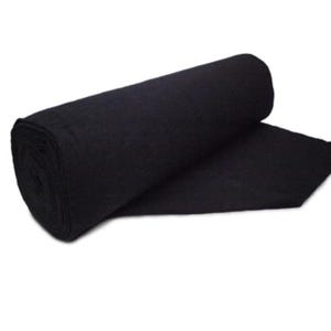 May include: A roll of black fabric, partially unrolled, against a white background. The fabric appears to be a solid, dark color, possibly felt or a similar material. The texture of the fabric is visible, suggesting a soft or slightly textured surface.