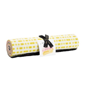 May include: Rolled fabric bundle with a white background and yellow dot pattern. A black ribbon and tag are attached, with the text "first light" and "RUBY STAR SOCIETY". The edges of the fabric are visible, showing a mix of colors.