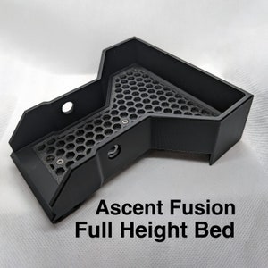 May include: Black 3D printed bed for an Ascent Fusion 3D printer. The bed has a honeycomb pattern and is designed for full height printing.