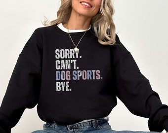 May include: Black sweatshirt with the text "SORRY. CAN'T. DOG SPORTS. BYE." in a vintage style font.
