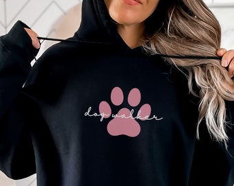May include: Black hoodie with a pink paw print and the text "dog walker" in white.