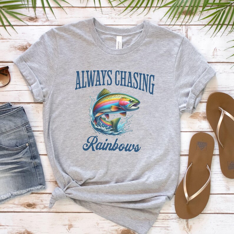 May include: A gray t-shirt with the text "ALWAYS CHASING Rainbows" and a colorful rainbow trout illustration.