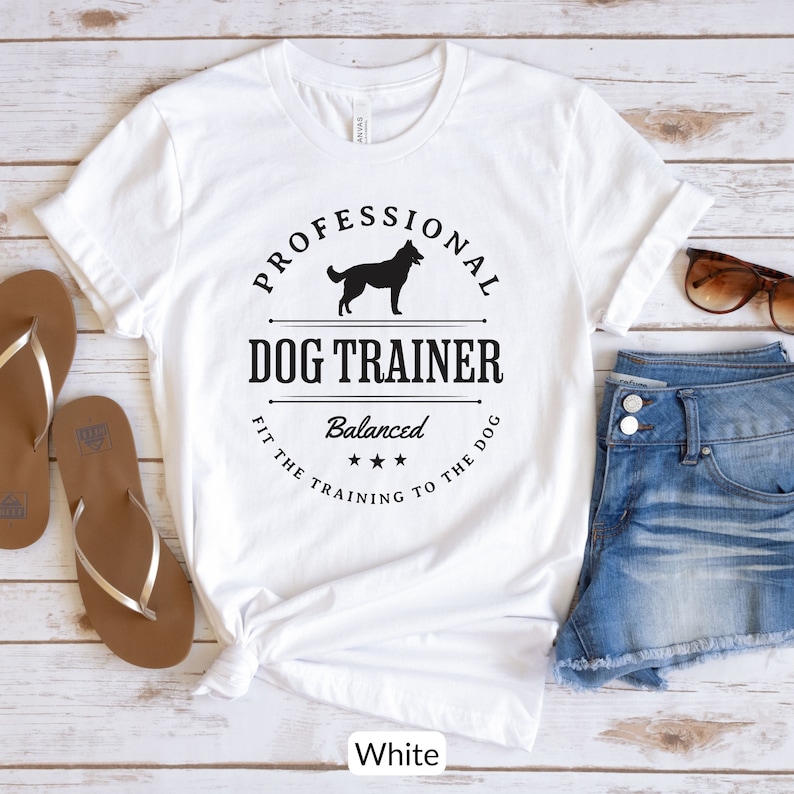 Balanced Dog Trainer T-Shirt: Fit the Training to the Dog. With a vintage style and handsome Belgian Malinois silhouette, its the perfect dog training apparel wear to appointments and lessons. And it makes a classy Malinois dog trainer gift!