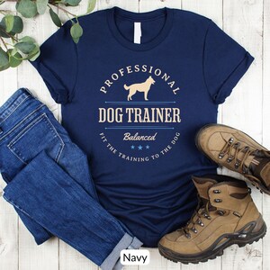 Balanced Dog Trainer T-Shirt: Fit the Training to the Dog. With a vintage style and handsome Belgian Malinois silhouette, its the perfect dog training apparel wear to appointments and lessons. And it makes a classy Malinois dog trainer gift!