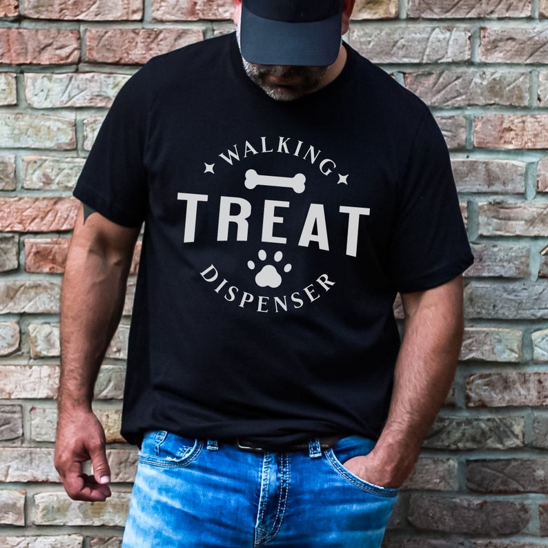 May include: A black t-shirt with a white graphic that says "Walking Treat Dispenser" with a bone and paw print.