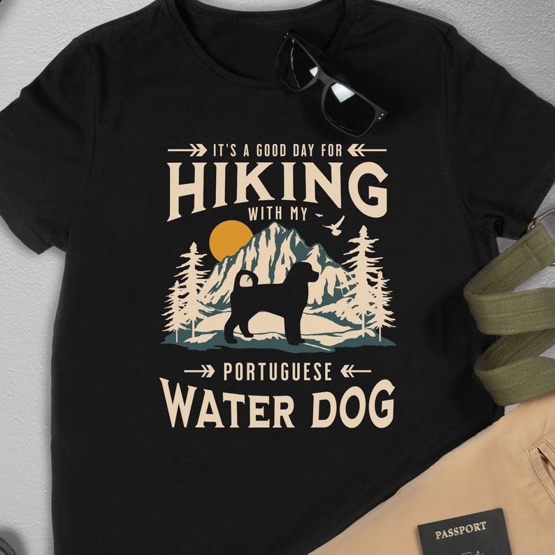 Hiking With My Portuguese Water Dog T-Shirt. A classic mountain design with Portuguese Water Dog silhouette, made for the Portie mom or dad who loves hiking with their dog. A great Portuguese Water Dog lover gift idea!