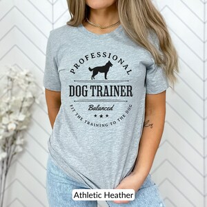 Balanced Dog Trainer T-Shirt: Fit the Training to the Dog. With a vintage style and handsome Belgian Malinois silhouette, its the perfect dog training apparel wear to appointments and lessons. And it makes a classy Malinois dog trainer gift!