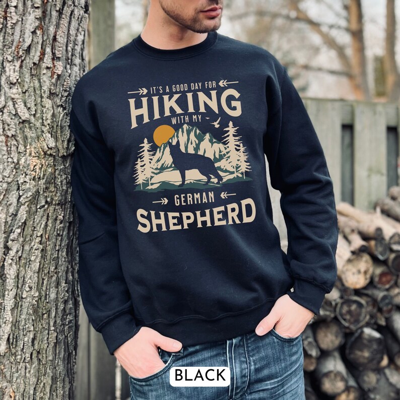 Hiking With My German Shepherd Sweatshirt. A beautiful and unique gift for the GSD lover in your life. With a classic mountain scene and handsome German Shepherd dog silhouette. Available in black and navy.
