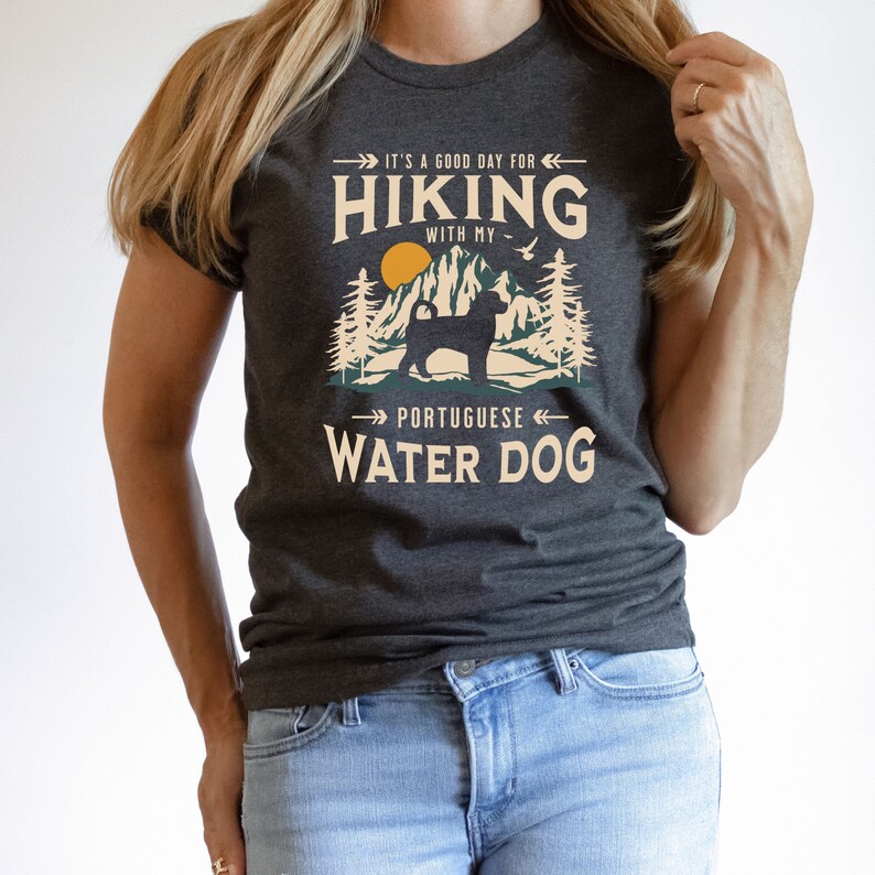 Hiking With My Portuguese Water Dog T-Shirt. A classic mountain design with Portuguese Water Dog silhouette, made for the Portie mom or dad who loves hiking with their dog. A great Portuguese Water Dog lover gift idea!