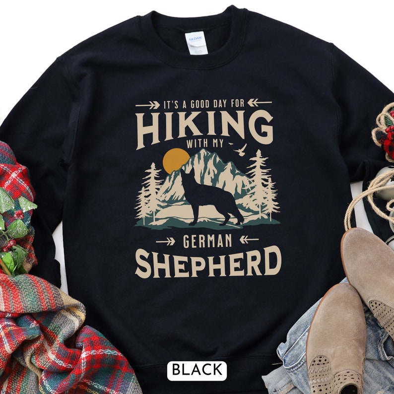 Hiking With My German Shepherd Sweatshirt. A beautiful and unique gift for the GSD lover in your life. With a classic mountain scene and handsome German Shepherd dog silhouette. Available in black and navy.