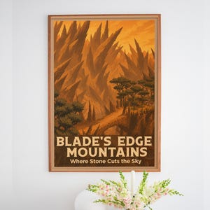 May include: A framed rectangular wall art print featuring a landscape illustration of sharp, jagged orange and brown mountain peaks. The text BLADE'S EDGE MOUNTAINS and Where Stone Cuts the Sky is printed in a light cream color at the bottom of the image.