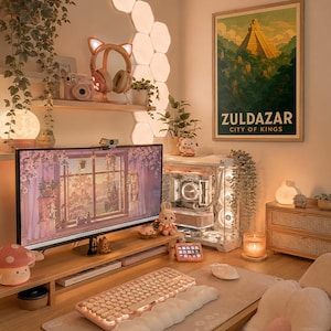 May include: A cozy, well-lit desk setup with a computer, keyboard, and mouse. The desk features a monitor displaying a floral scene, a pink keyboard, and a decorative mushroom lamp. A poster reading "Zuldazar, City of Kings" hangs on the wall.
