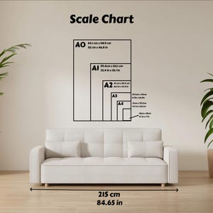 May include: A white sofa with two pillows is positioned below a wall-mounted scale chart. The chart displays the dimensions of paper sizes A0 through A4, with measurements in both centimeters and inches. The overall width of the sofa is 84.65 inches.