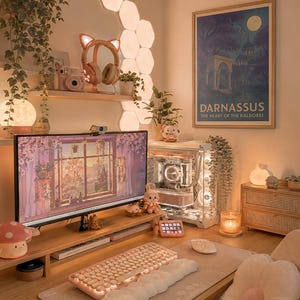 May include: A cozy, well-lit desk setup with a computer, keyboard, and mouse. The desk features a monitor displaying a floral scene, a pink keyboard, and a plush mousepad. Decorative elements include a mushroom lamp, plants, and a framed poster that reads "Darnassus".