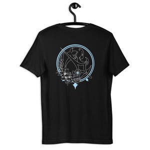 May include: Black t-shirt featuring a white outline of a woman holding a sword, encircled by a blue circle with stars and flowers. The design is centrally positioned on the back of the shirt.