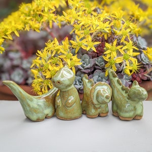 Small dinosaurs, ceramic brontosaurus, triceratops, and stegosaurus
