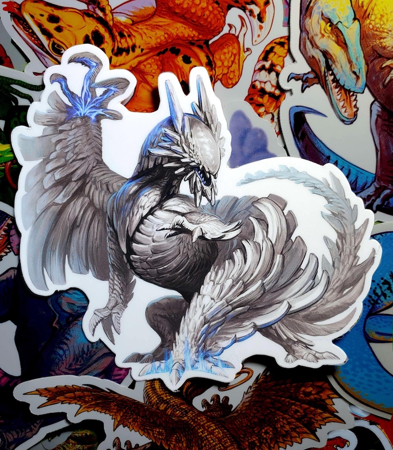 May include: A white and gray feathered creature with blue accents. The creature has a long tail and large wings. It is standing on its hind legs with its claws extended.