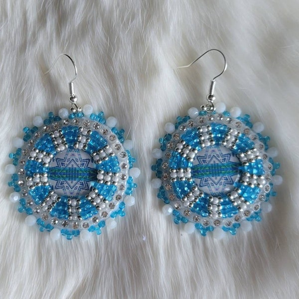 COOL TONED COLLECTION 2023 - Circular, Aztec cabs made with white, and blue czech beads with silver accents.