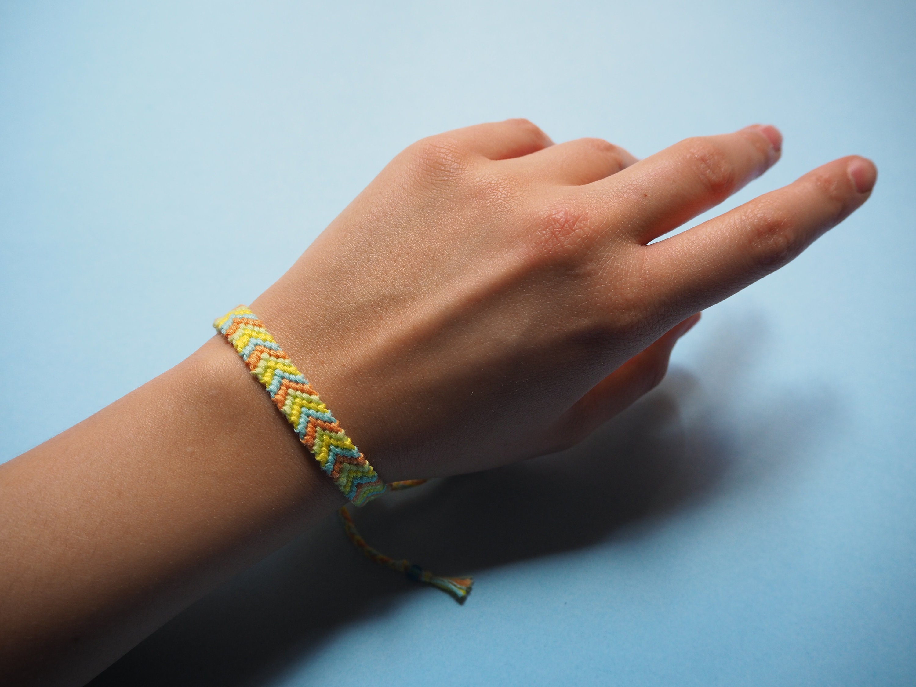 Friendship bracelet in four colors yellow green orange blue Etsy