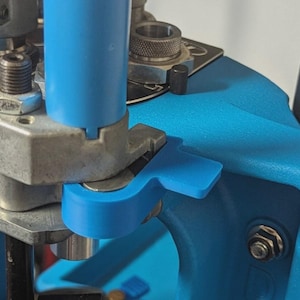 May include: A white ceramic mug with a black handle and the text "But First, Coffee" in a black, bold font. The mug is on a white surface. The mug is approximately 4 inches tall.