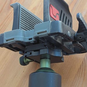 May include: A white ceramic mug with a black handle and the text "But First, Coffee" in a bold, black font. The mug is set against a blurred background, suggesting a cozy setting.