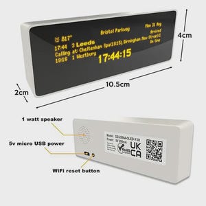 May include: A white digital clock, 10.5cm long and 4cm high, with a 2cm depth. The display shows train arrival information in yellow text. Features include a 1-watt speaker, a 5v micro USB power port, and a WiFi reset button.