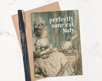 May include: A greeting card with a vintage illustration of a woman in a powdered wig feeding a cat. The text on the card reads "perfectly sane cat lady".
