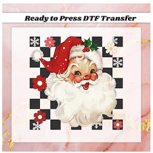 May include: A vintage-style Santa Claus graphic with a red hat and white beard, set against a black and white checkered background. The image includes red flowers, snowflakes, and the text "Ready to Press DTF Transfer".