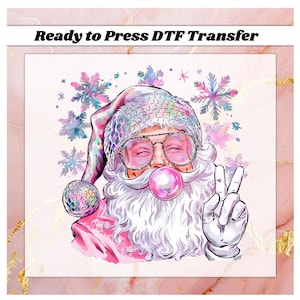May include: A whimsical Santa Claus illustration with a peace sign, wearing a sequined hat and glasses, blowing a bubblegum bubble. The image includes the text "Ready to Press DTF Transfer" and snowflake accents.