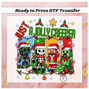 May include: A DTF transfer featuring pixelated characters in Santa hats with the text "Just a Jolly Creeper." The design includes a snowman, Christmas tree, and festive decorations. The background is a mix of colors.