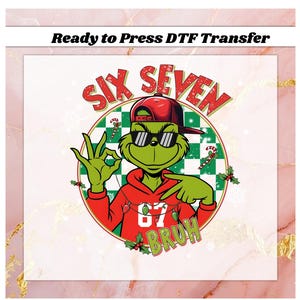 May include: A DTF transfer featuring a green cartoon character wearing a red hoodie, sunglasses, and a backward red cap. The character is giving an 'okay' hand gesture. The words "SIX SEVEN BRUH" are in the design, along with candy canes and holly.