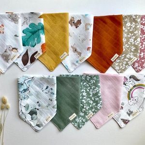 May include: A collection of 10 colourful and patterned bandana bibs for babies. The bibs feature various designs, including floral patterns, animal prints, and abstract shapes. The bibs are made of soft and absorbent fabric, making them ideal for drooling babies.