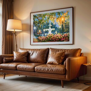 May include: A brown leather sofa with two matching throw pillows and a rolled armrest cushion. A framed painting of a fountain and flowers hangs above the sofa. A floor lamp and side table with a candle complete the living room setting.