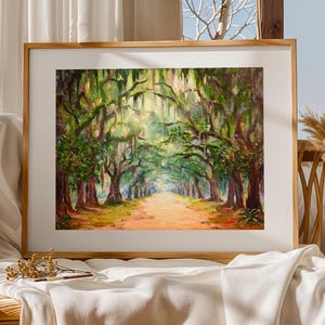 May include: A framed landscape painting showing a tree-lined path. The artwork uses a vibrant palette of greens, browns, and yellows, focusing on the trees and the path leading into the distance. The painting is set in a wooden frame.