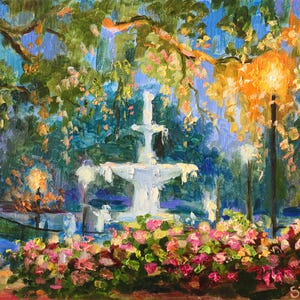 May include: Oil painting of a park scene with a white fountain as the focal point. The artwork features lush greenery, colorful flowers, and warm lighting from street lamps. The artist's signature is in the bottom right corner.