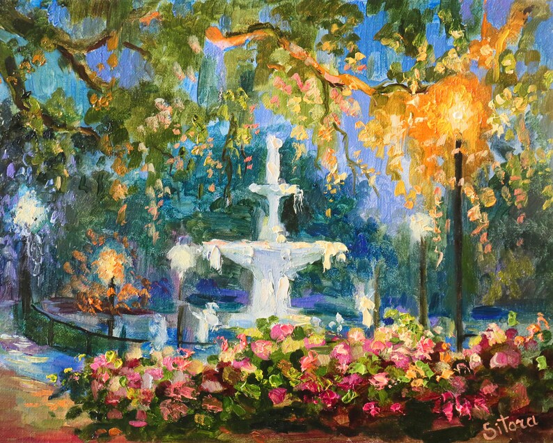 May include: Oil painting of a park scene with a white fountain as the focal point. The artwork features lush greenery, colorful flowers, and warm lighting from street lamps. The artist's signature is in the bottom right corner.