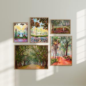 May include: Five framed landscape paintings with wooden frames are displayed on a white wall. The paintings depict park scenes with fountains, trees, and pathways. The artwork features vibrant colours and impressionistic brushstrokes.