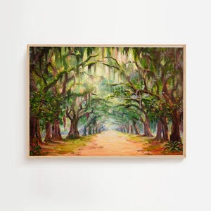 May include: Oil painting of a tree-lined path. The artwork features a dirt road leading into the distance, framed by large trees with green foliage and hanging moss. The painting is in a wooden frame.