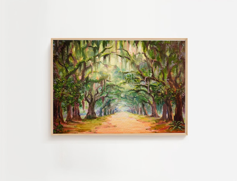 May include: Oil painting of a tree-lined path. The artwork features a dirt road leading into the distance, framed by large trees with green foliage and hanging moss. The painting is in a wooden frame.