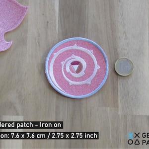 May include: Pink and white embroidered iron-on patch with a spiral design. The patch is 2.75 inches in diameter.  Embroidered patch - Iron on Dimension: 7.6 x 7.6 cm / 2.75 x 2.75 inch X GEEKY △ PATCHES
