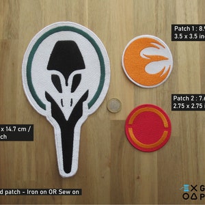 May include: Three embroidered iron-on patches with different designs. The first patch is orange and white with a symbol that resembles a stylised letter E. The second patch is red and orange with a circle design. The third patch is green and white with a stylised alien head design. The text on the image reads "Patch 1: 8.9 x 8.9 cm / 3.5 x 3.5 inch", "Patch 2: 7.6 x 7.6 cm / 2.75 x 2.75 inch", "Patch 3: 25 x 14.7 cm / 9.85 x 5.5 inch", "Embroidered patch - Iron on OR Sew on", "X GEEKY ΟΔ PATCHES".