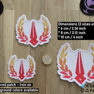 May include: Three embroidered iron-on patches with a red and white design of a stylized quill pen with a laurel wreath. The patches are available in three sizes: 2.36 inches, 3.15 inches, and 4 inches. The text "X GEEKY PATCHES" is visible in the bottom right corner of the image.
