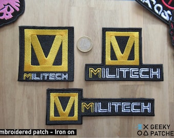 May include: Embroidered patches with the word "MILITECH" in white and a gold "V" design on a black background. The patches are in three different shapes: square, rectangular, and elongated rectangular. The text "Embroidered patch - Iron on" is at the bottom.