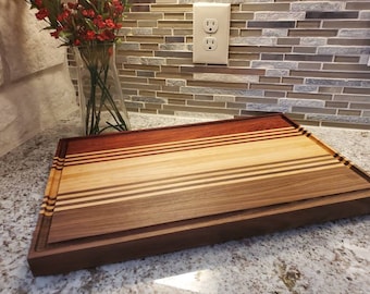 Padauk/Walnut/Maple edge grain cutting board