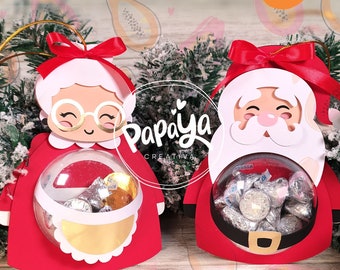 Peut inclure: Modèle d'ornement de Noël imprimable représentant le Père Noël et Mme Claus tenant une sphère en plastique transparente pour des bonbons ou de petits cadeaux. Le modèle est décoré d'accents rouges, blancs et dorés. L'arrière-plan présente un motif de papaye.