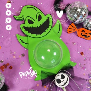 May include: A green Oogie Boogie-themed Halloween decoration with a clear bubble and a black bow. The decoration has a smiling face and is surrounded by disco balls, a jack-o'-lantern candy, and confetti. The text "Digital File" and a heart are also visible.