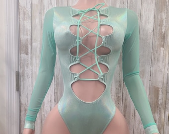 May include: A mint green bodysuit with long sleeves and a lace-up front. The sleeves are sheer and the bodysuit has a shiny finish.