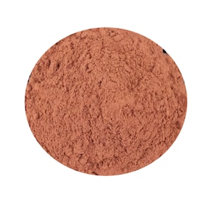 May include: A close-up view of a pile of loose, reddish-brown powder. The powder is finely ground and has a uniform texture.