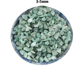 May include: A bowl filled with green jade chips, ranging in size from 3 to 5 millimeters.