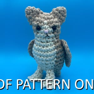 May include: A crocheted owl figurine in shades of gray and white, with a light blue background. The owl has large eyes, a small pink nose, and a textured appearance. The text "PDF PATTERN ONLY" is displayed at the bottom.